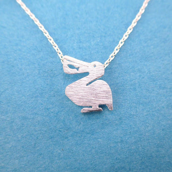 Pelican Silhouette with Fish Cut Out Shaped Charm Necklace in Silver | DOTOLY | DOTOLY